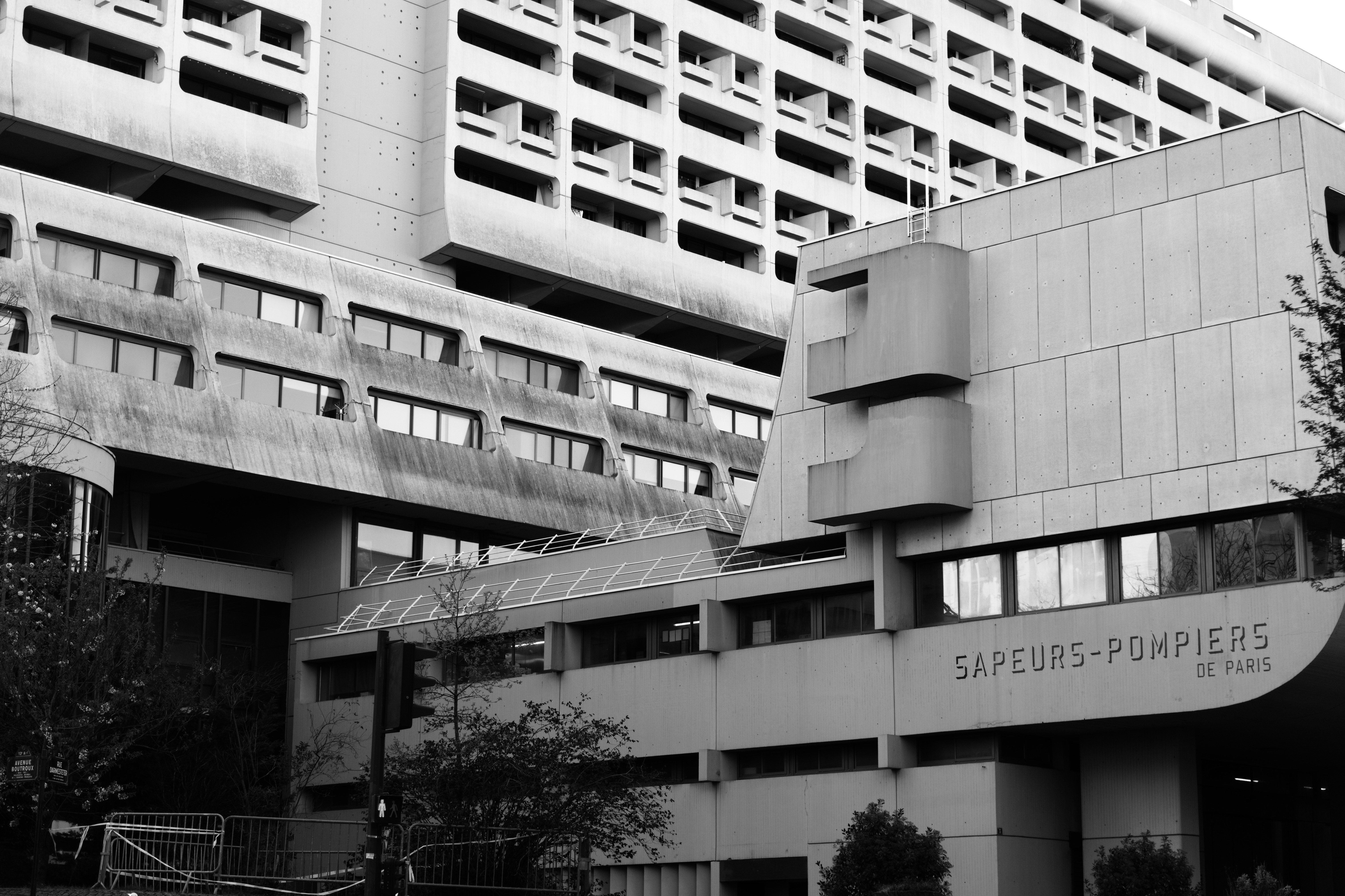 Brutalist fire station complex with connecting bridge and corner tower