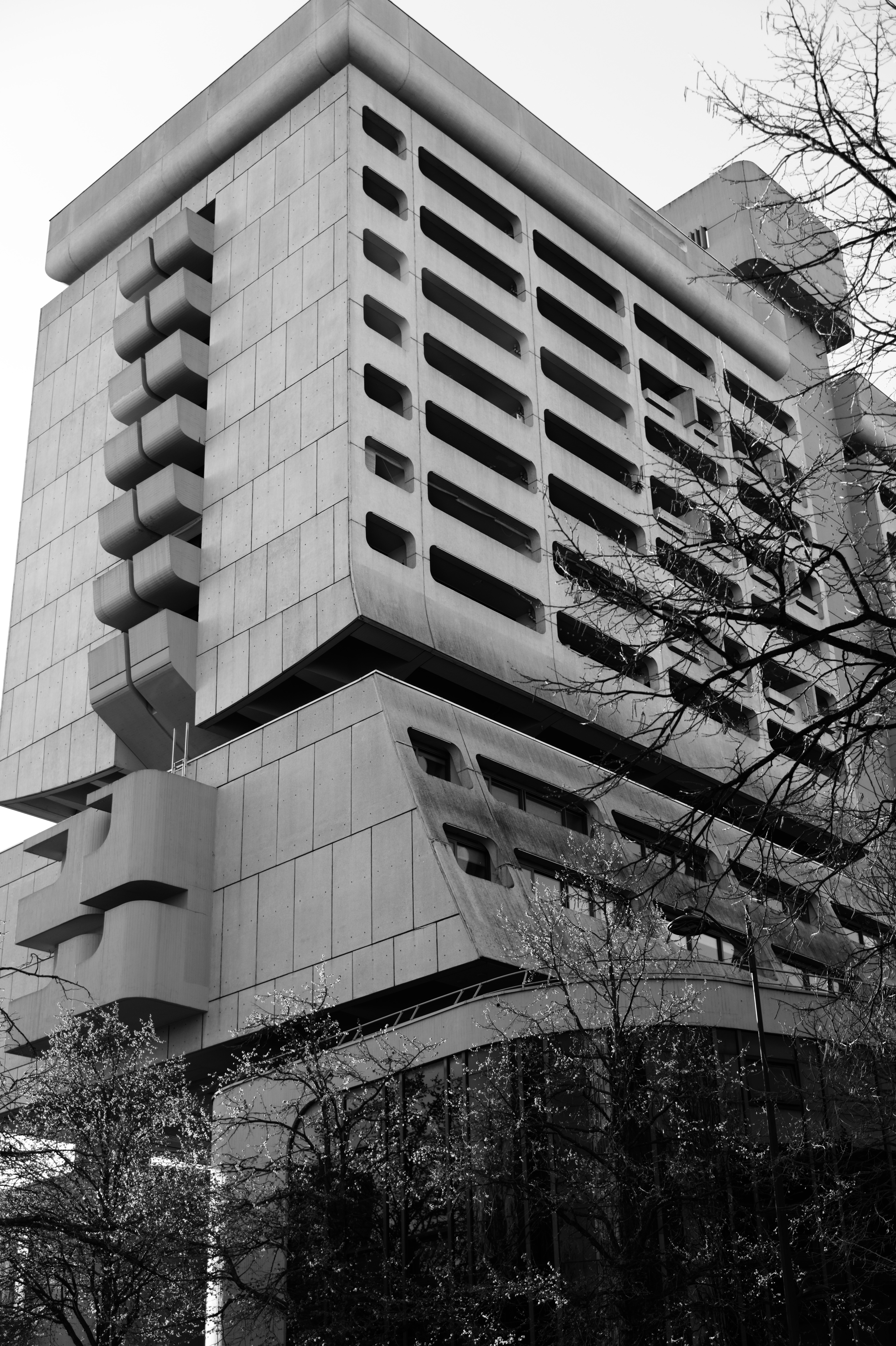 Precast concrete facade with modular panels and deep-set horizontal windows
